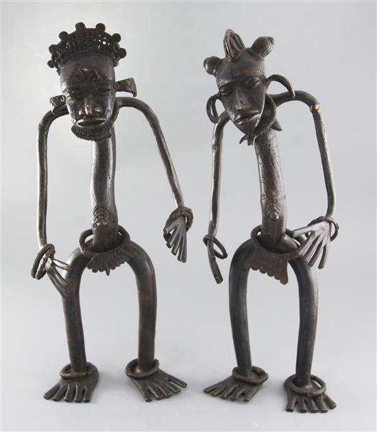 A pair of Nigerian bronze cham chams or protection figures, with ring bracelets to the wrist and ankles, height 48cm